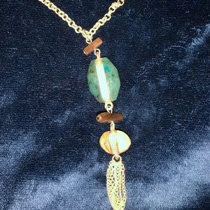 Long gold chain with green & yellow stone & tassel